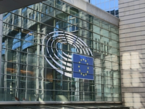 A wall of glass windows with the EU logo